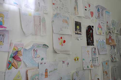 Drawings and messages adorn the wall of a women's shelter. 