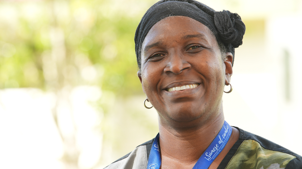 A woman smiles into the camera