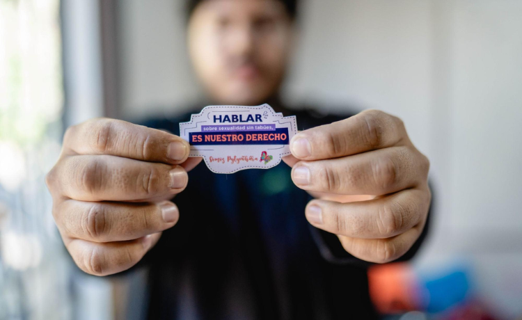  A young man holds a sticker.