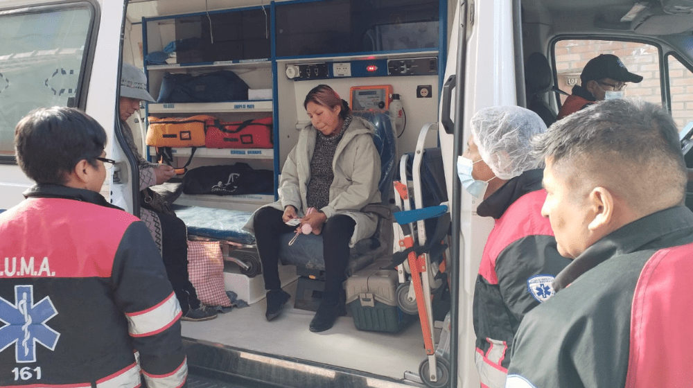 A woman sits in an ambulance.