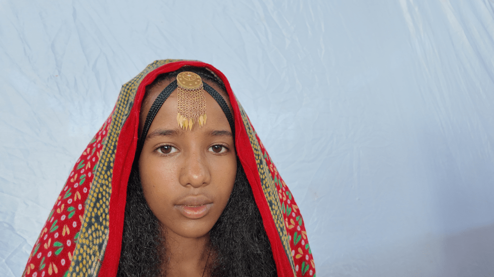 Young girl stares into camera.