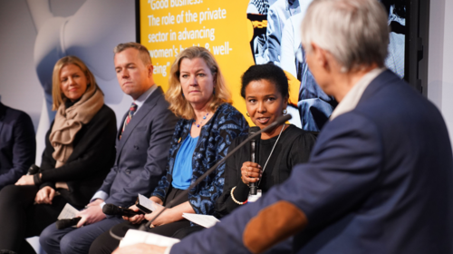 Group of people converse at an event.